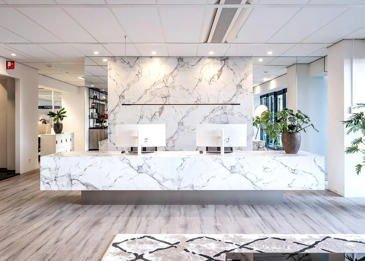 Modern kantoorinterieur met lichte bureaus en grote ramen